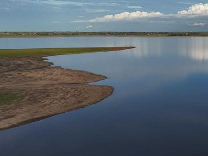 A scenic aerial view of the waterfront, showcasing the natural shoreline and expansive water body.