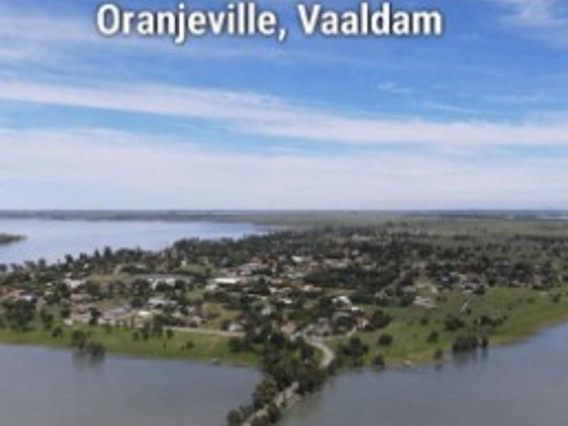 An aerial view of the Oranjeville area near the Vaaldam, showcasing the surrounding landscape and water proximity.