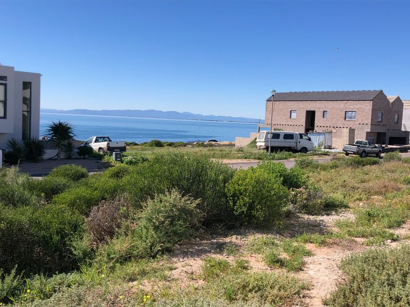 A scenic view of the coastline and ocean from the residential property, showcasing the surrounding landscape and nearby coastal homes.