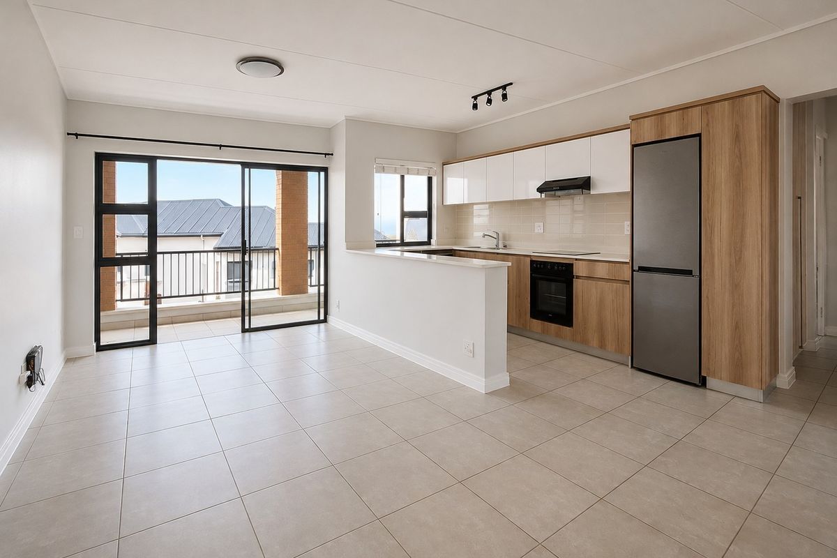 Modern open-plan kitchen and living area featuring neutral tiled flooring, sleek cabinetry, built-in appliances, and direct access to a private balcony.