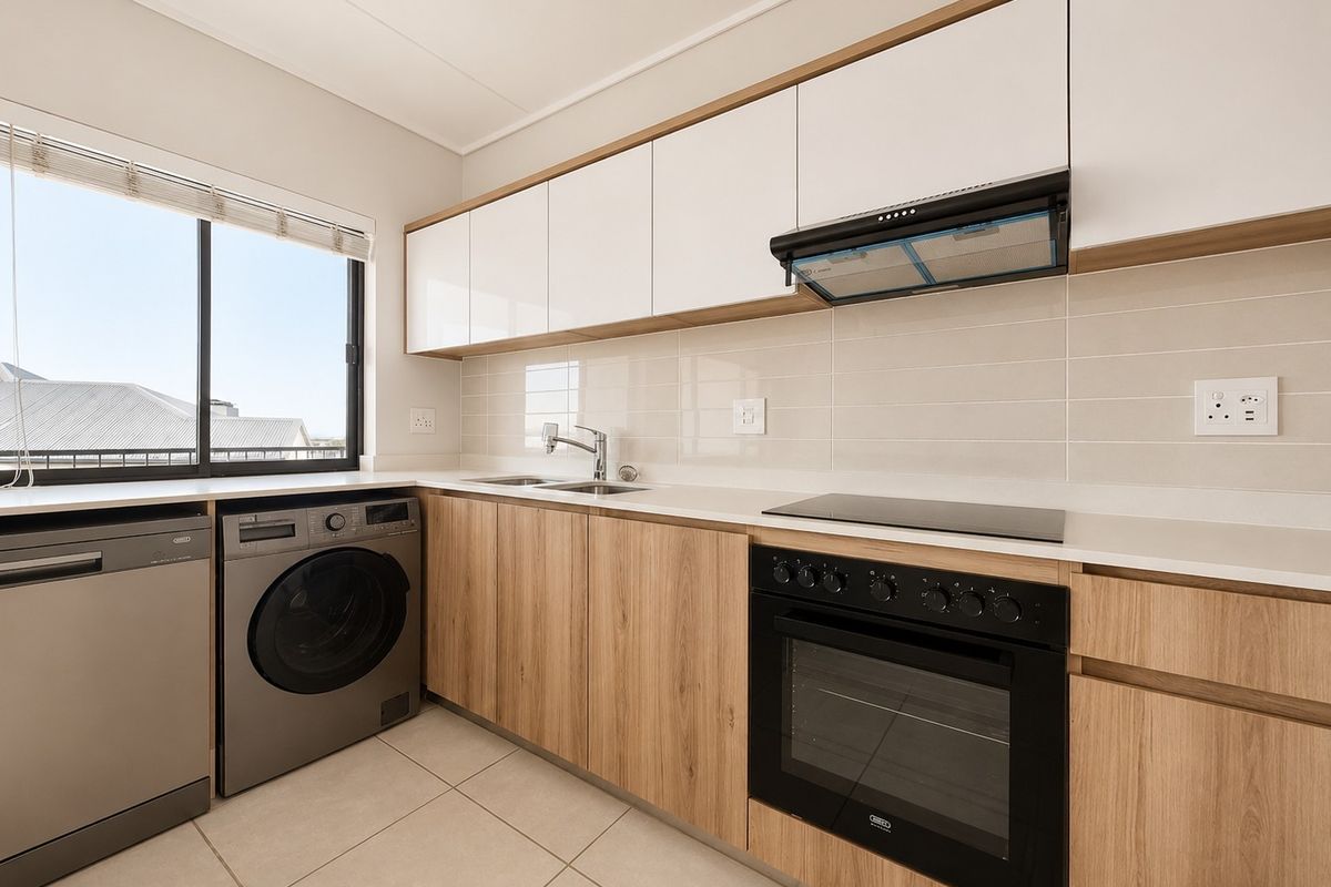 Modern kitchen featuring sleek wood-grain and white cabinetry, stone countertops, integrated appliances, and a tiled backsplash with ample natural light.