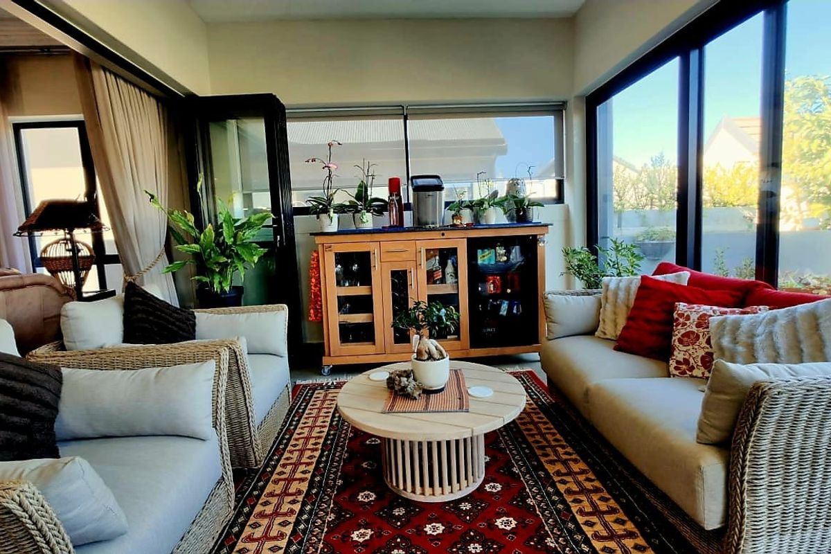 A bright and airy living room featuring large sliding glass doors that provide ample natural light and seamless access to the outdoor area.