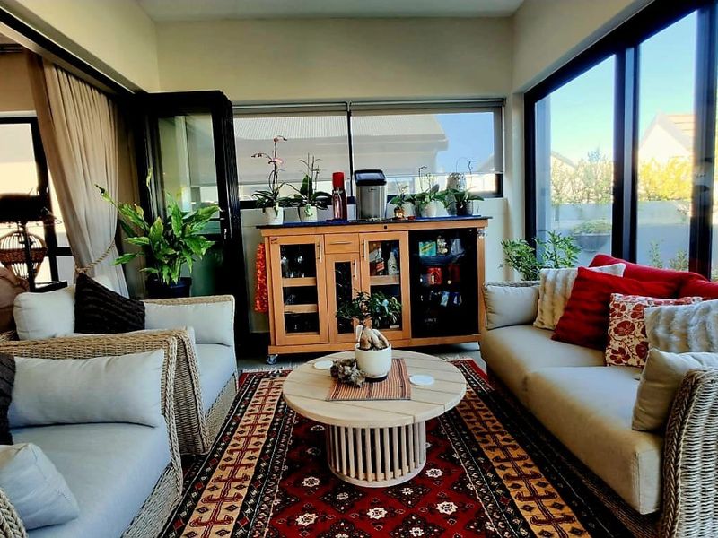 A bright and airy living room featuring large sliding glass doors that provide ample natural light and seamless access to the outdoor area.
