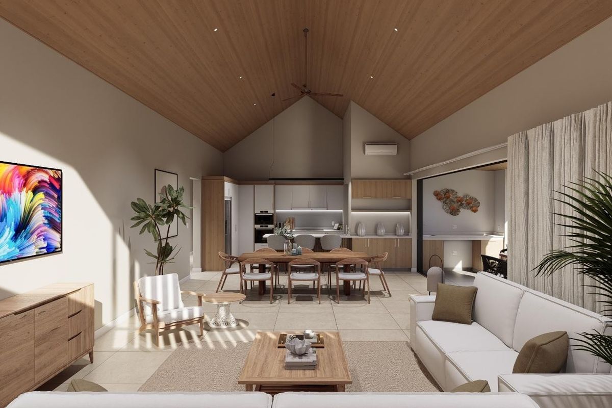 Spacious open-plan living and dining area featuring a high vaulted timber ceiling, modern kitchen cabinetry, and seamless flow to the outdoor patio.