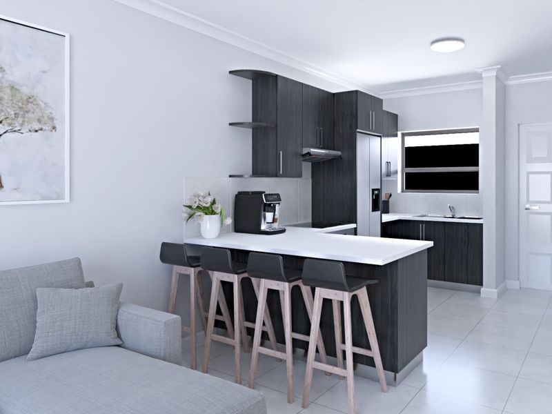 Modern open-plan kitchen featuring dark wood cabinetry, a breakfast bar, and tiled flooring, seamlessly integrated with the living area.
