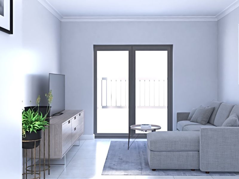 A bright and modern living room featuring neutral tiled flooring, cove cornicing, and a large sliding glass door providing access to an outdoor area.