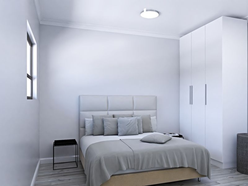 A clean, modern bedroom featuring a built-in wardrobe, neutral finishes, and a flush mount ceiling light.