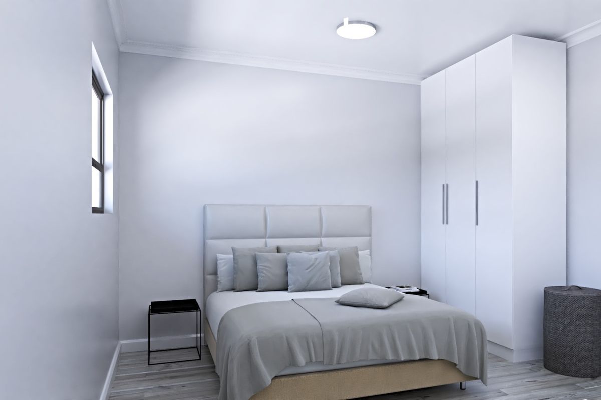 A clean, modern bedroom featuring a built-in wardrobe, neutral finishes, and a flush mount ceiling light.