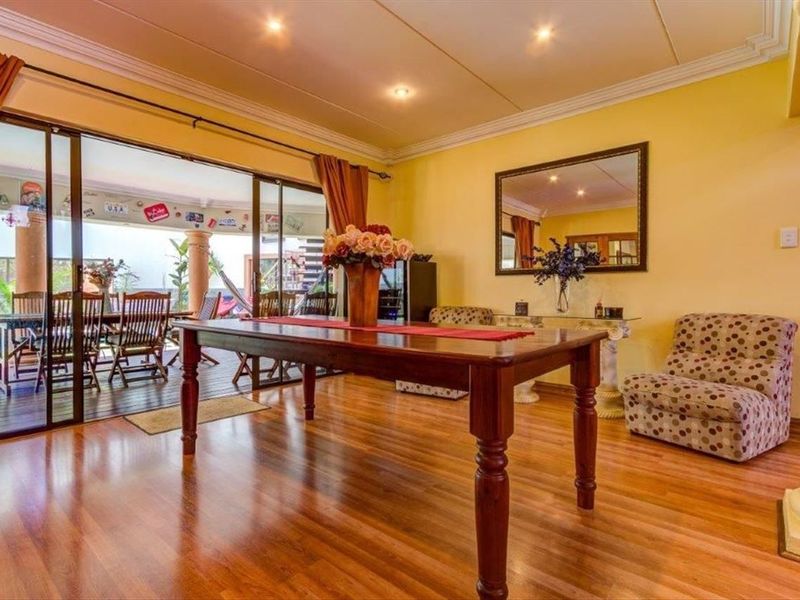 Dining room featuring hardwood flooring, recessed lighting, and large sliding glass doors providing seamless access to the outdoor patio area.