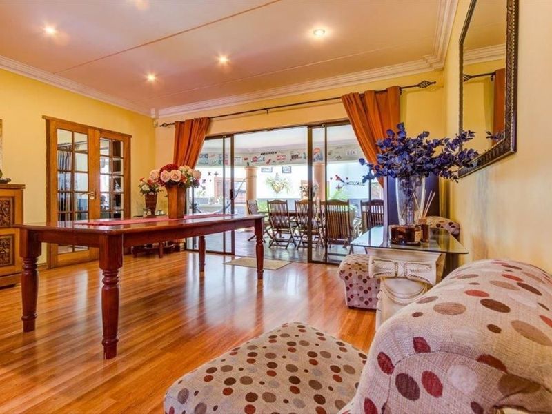 Dining room featuring hardwood flooring, recessed lighting, and large sliding glass doors providing seamless access to the outdoor patio area.