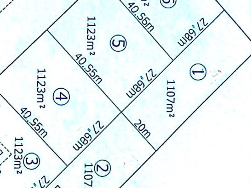 A site plan showing the subdivision layout of residential plots, including individual land sizes and the location of an existing garage.