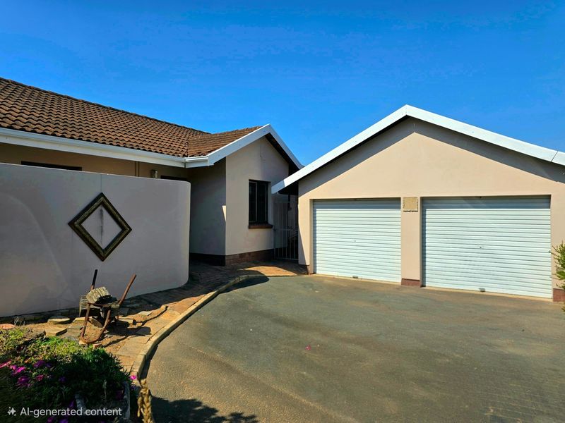 Front exterior view of the townhouse featuring a double garage with roller doors, a paved driveway, and a tiled roof.