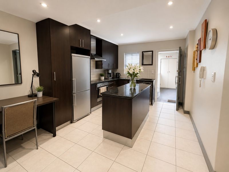 Modern kitchen featuring dark wood cabinetry, granite countertops, a central island, and tiled flooring, offering a functional and well-maintained cooking space.