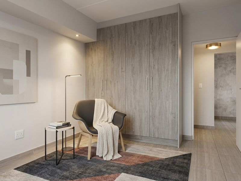 A modern bedroom featuring light wood-grain built-in wardrobes, neutral tiled flooring, and recessed ceiling lighting.