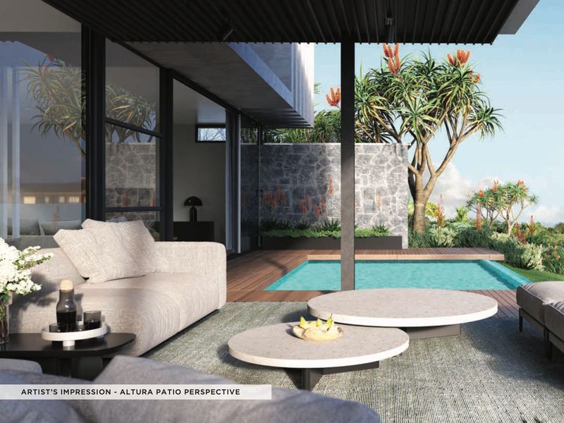 A modern covered patio featuring timber decking, a stone feature wall, and direct access to a private swimming pool.