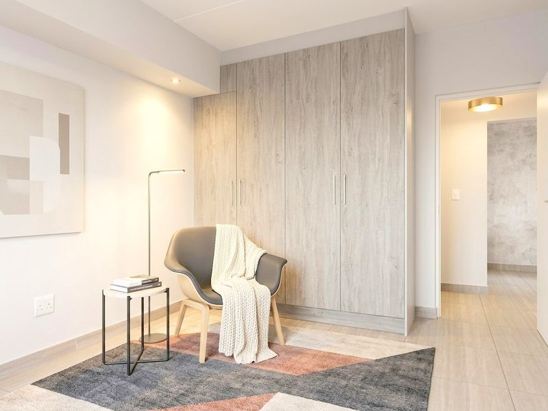 A modern bedroom featuring light wood-grain built-in wardrobes, neutral tiled flooring, and recessed ceiling lighting.