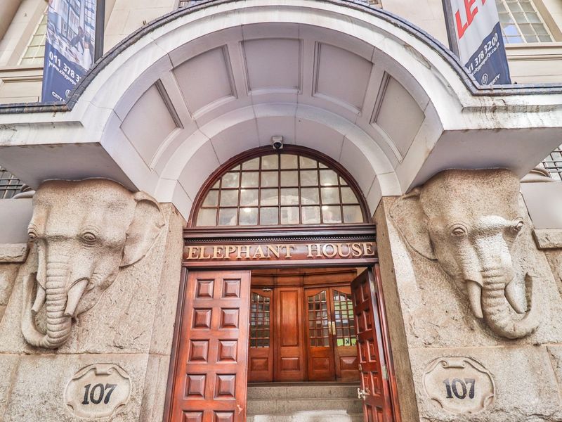 The historic Elephant House entrance features iconic stone elephant sculptures, an arched portico, and grand timber panelled doors.