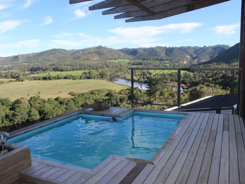 Elevated timber deck featuring a plunge pool with expansive views over the surrounding valley, river, and mountain landscape.