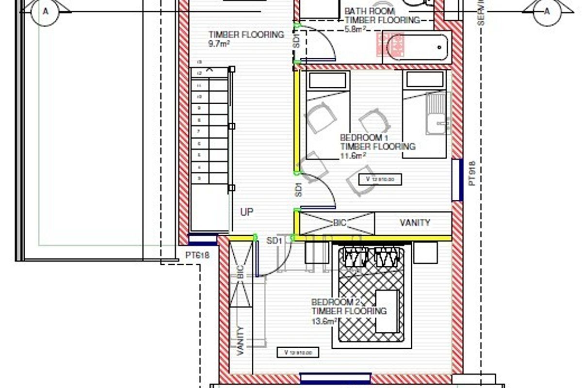 Architectural floor plan showing the layout of two bedrooms, a bathroom, and an outdoor balcony area.