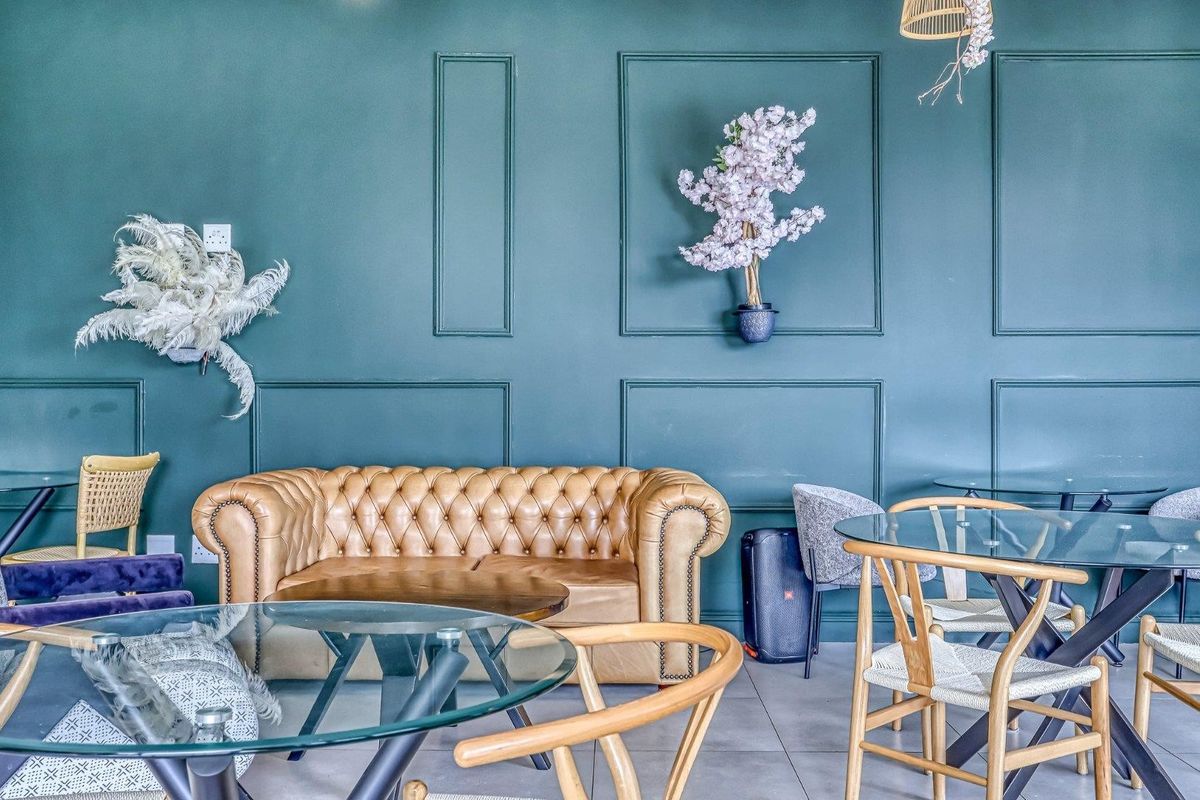 A stylish living area featuring decorative wall paneling and neutral tiled flooring, creating a sophisticated and modern atmosphere.