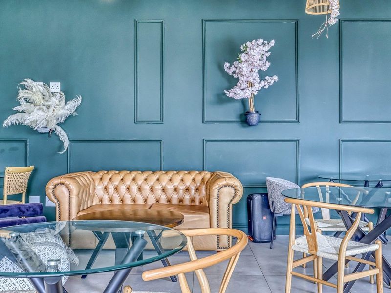 A stylish living area featuring decorative wall paneling and neutral tiled flooring, creating a sophisticated and modern atmosphere.
