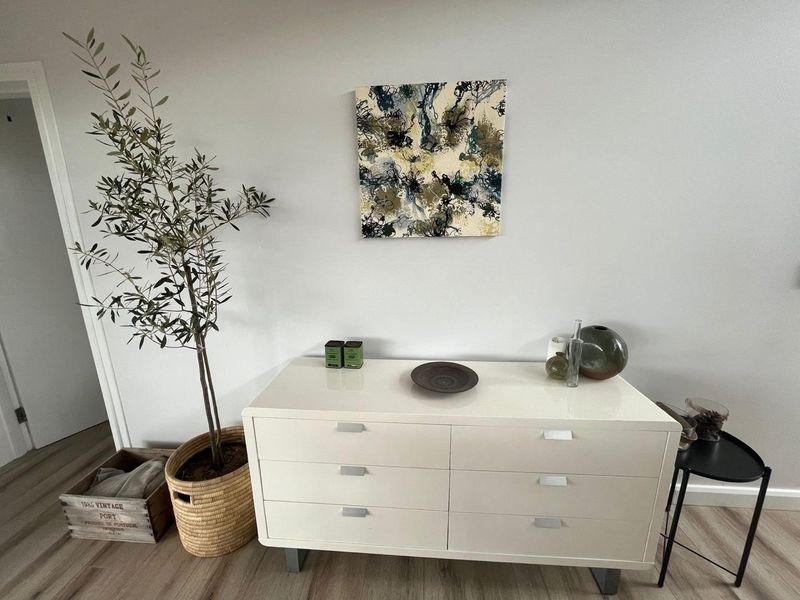 A well-maintained interior space featuring light-toned wood-look flooring and neutral wall finishes.