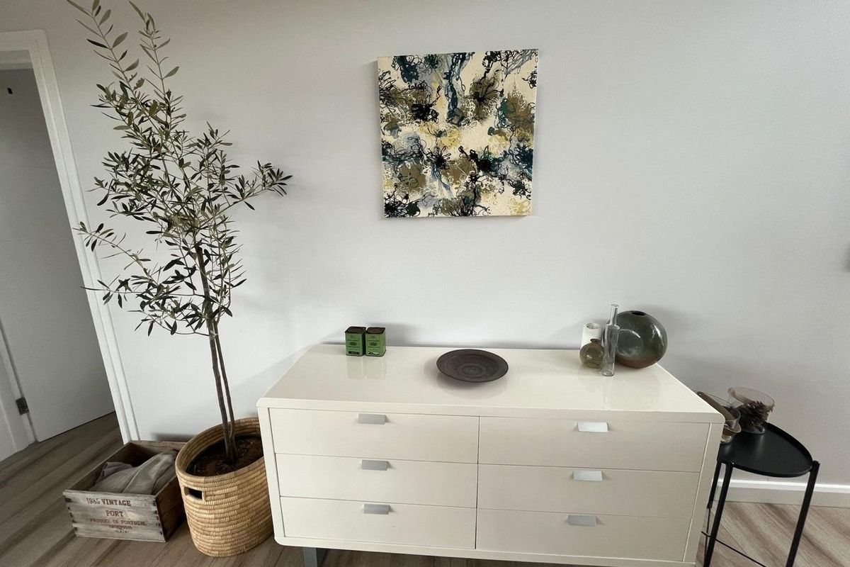 A well-maintained interior space featuring light-toned wood-look flooring and neutral wall finishes.