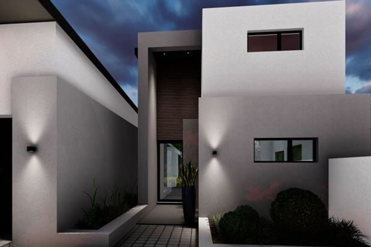 A modern two-story residential facade featuring clean architectural lines, recessed entrance, integrated wall lighting, and landscaped garden beds.