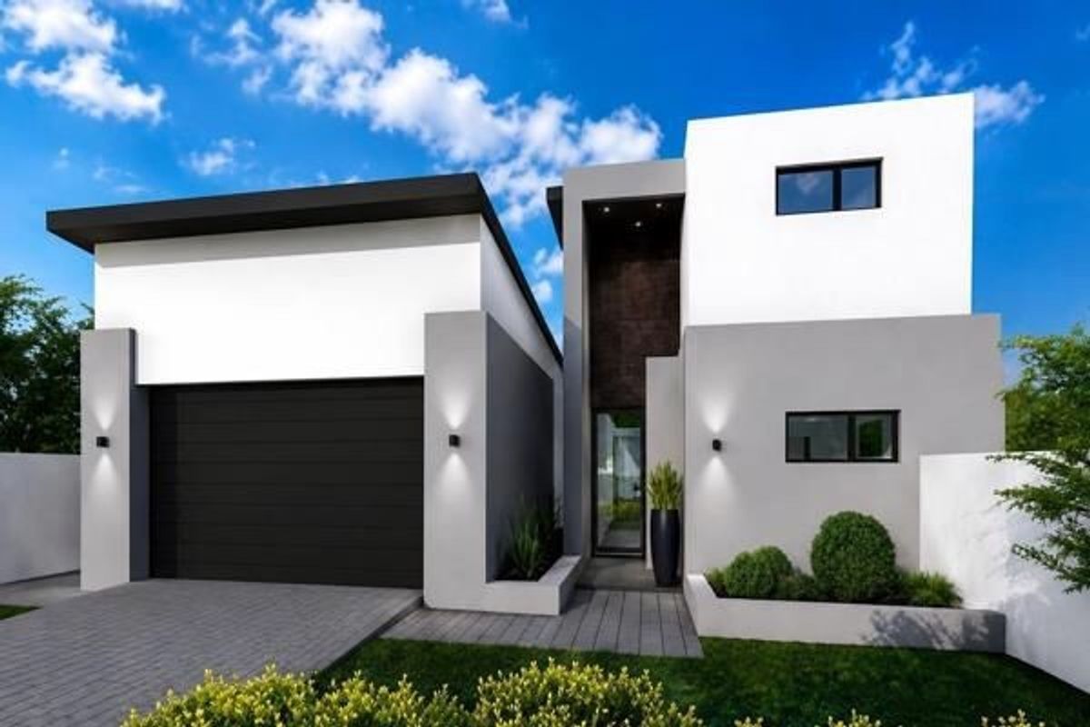 Modern two-story residential facade featuring a sleek garage, clean architectural lines, and a well-maintained front garden entrance.