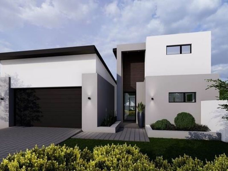 A modern two-story residential facade featuring a sleek garage, paved driveway, and contemporary architectural design with clean lines and integrated exterior lighting.
