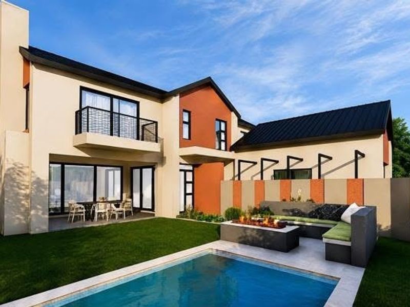 Modern rear exterior featuring a swimming pool, built-in fire pit area, covered patio, and a balcony overlooking the landscaped garden.