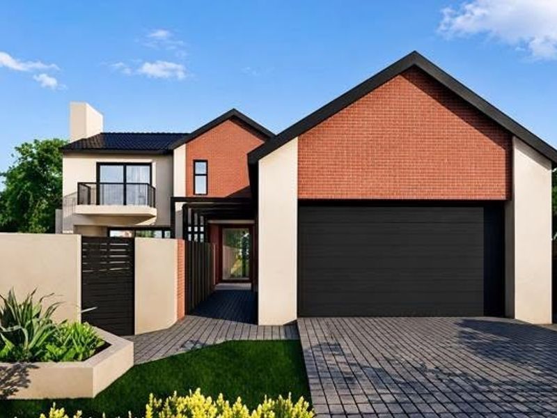 Modern double-story residential home featuring a brick and plaster facade, double garage, and a private balcony.