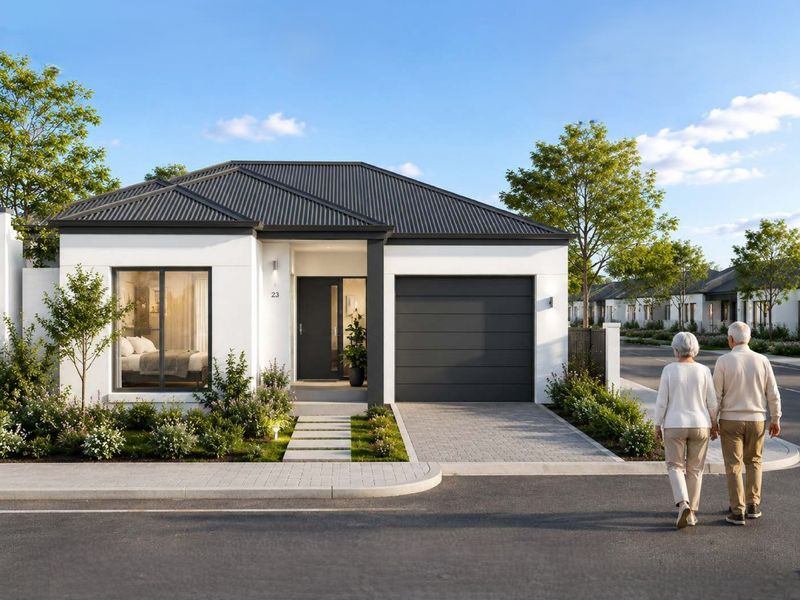 A modern single-story residential home featuring a clean white facade, dark metal roof, paved driveway, and a well-maintained front garden.