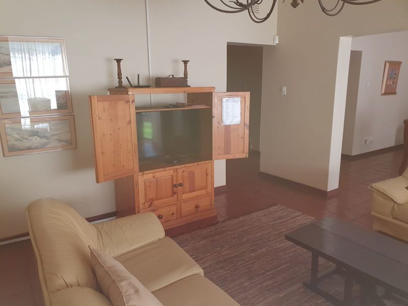 A living room area featuring tiled flooring and neutral wall finishes, providing a functional space for relaxation.
