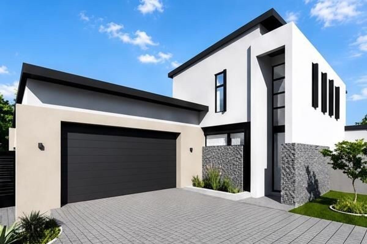 Modern double-storey home featuring a sleek facade with stone cladding, a paved driveway, and a spacious double garage.