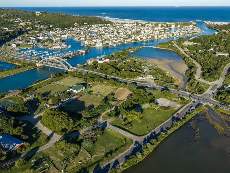 An aerial view of the coastal residential area, showing the estuary, bridge, and surrounding landscape.