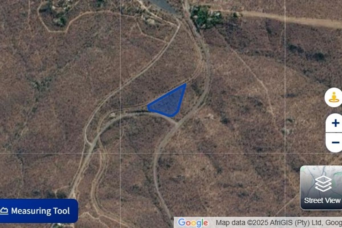 An aerial satellite view showing the boundaries of the vacant residential land plot within the surrounding landscape.