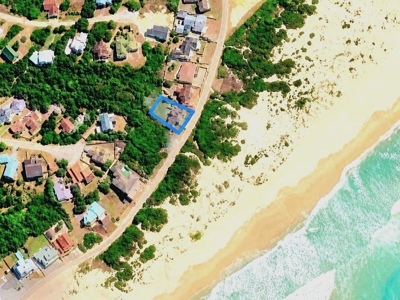 An aerial view showing the property's prime coastal location, situated in close proximity to the beach and surrounding residential neighborhood.