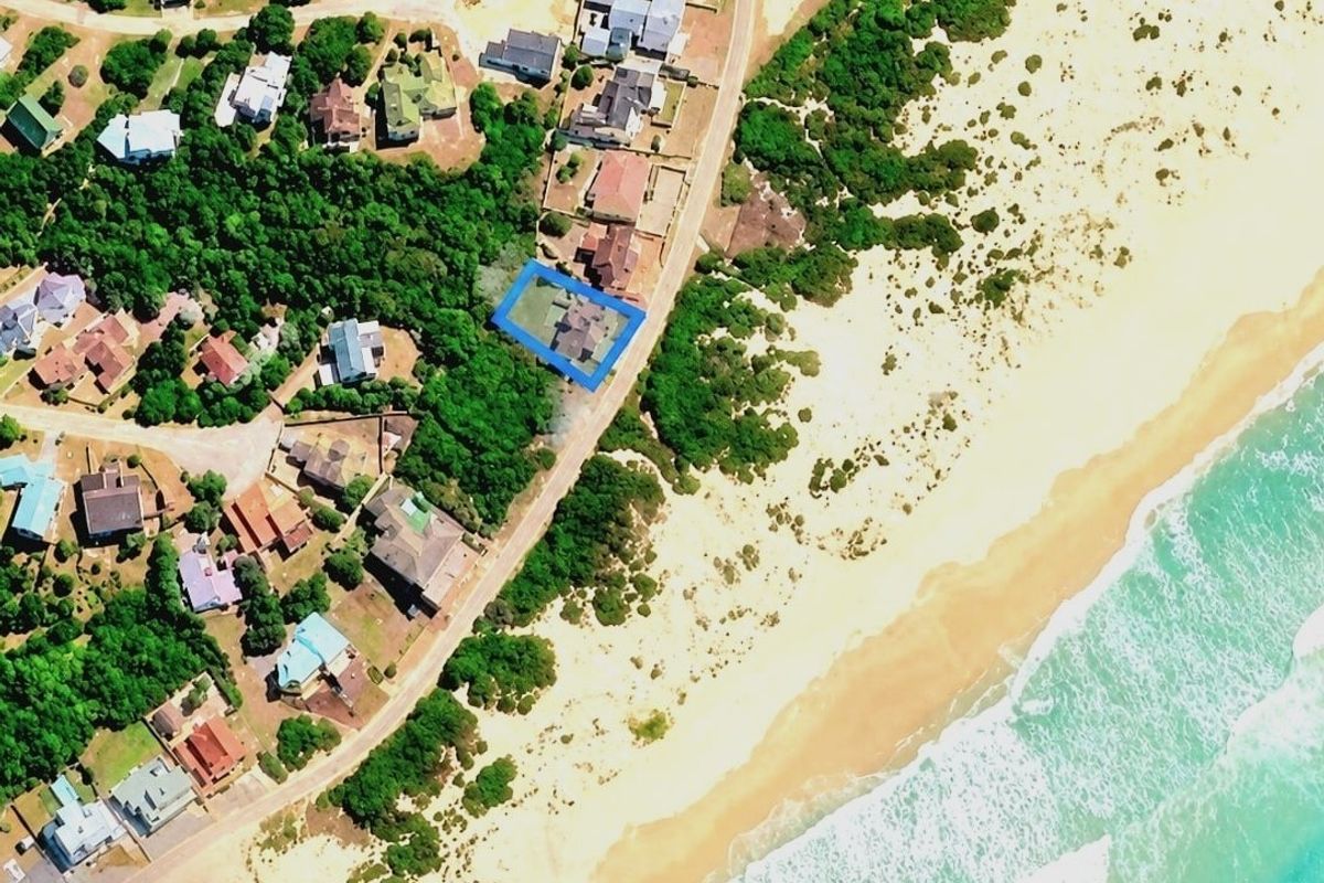 An aerial view showing the property's prime coastal location, situated in close proximity to the beach and surrounding residential neighborhood.