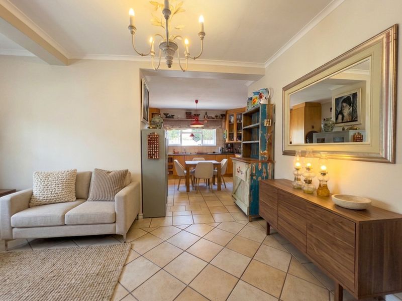 Open-plan living and dining area featuring tiled flooring, neutral walls, and a seamless transition into the kitchen space.