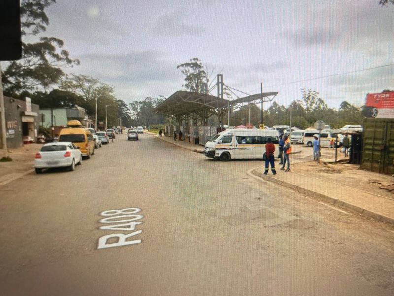 Street view of the R408 road showing surrounding commercial infrastructure, public transport facilities, and general road access.