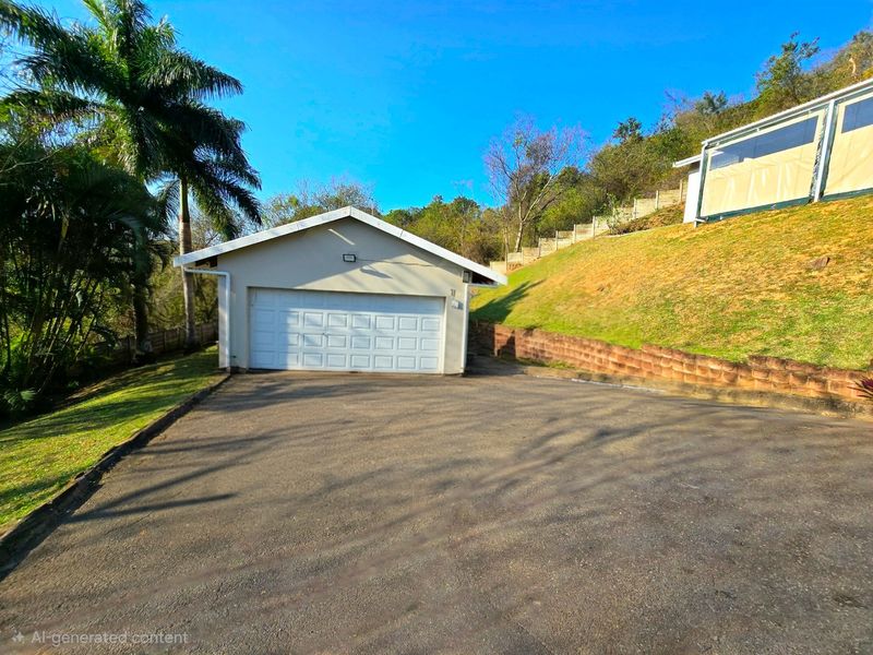 A detached garage with a white sectional door, situated at the end of a paved driveway with landscaped terraced grounds.