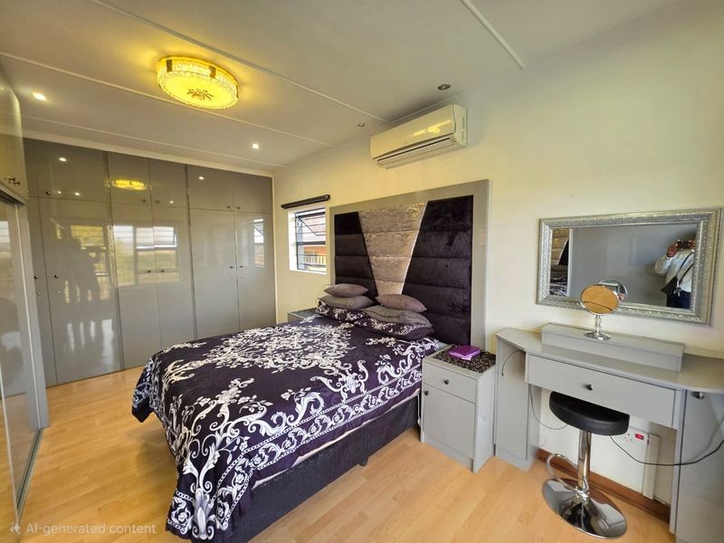 A well-maintained bedroom featuring built-in cupboards, laminate flooring, and a split-system air conditioner for climate control.