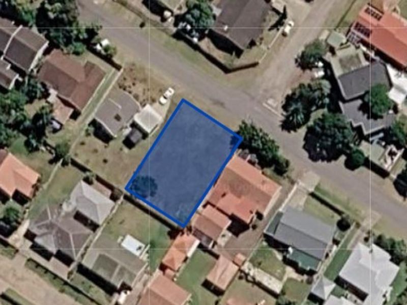 Aerial view of a vacant residential land parcel situated within an established suburban neighborhood.