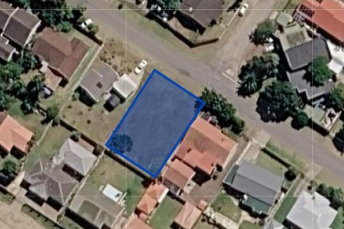 Aerial view of a vacant residential land parcel situated within an established suburban neighborhood.
