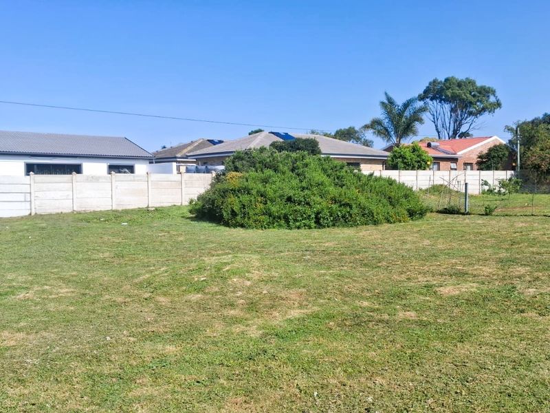 A spacious, level residential plot featuring a well-maintained lawn and secure precast concrete boundary walls, offering a clear space for future development.