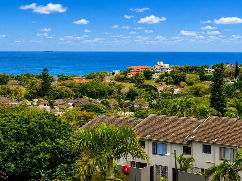 Elevated view overlooking the surrounding residential neighborhood with a clear outlook towards the ocean.