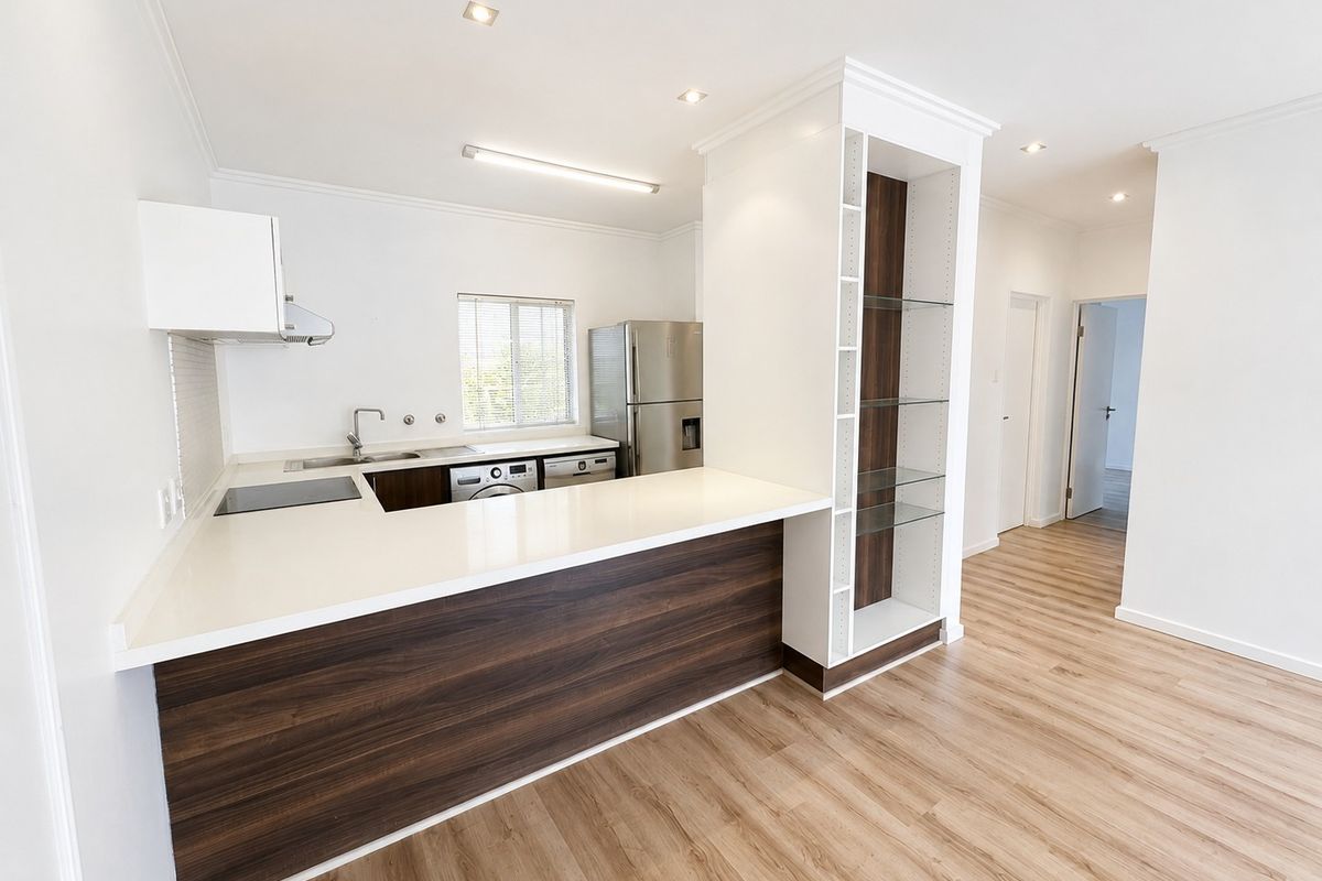 Modern, clean-lined kitchen featuring quartz countertops, dark wood-grain cabinetry, integrated shelving, and high-quality laminate flooring in an open-plan layout.