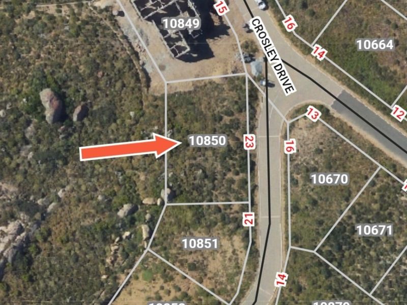 An aerial view of vacant residential plot 10850 located on Crosley Drive, showing the site boundaries and surrounding landscape.