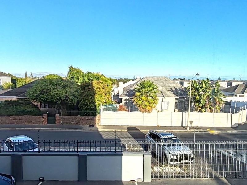 An elevated view overlooking the street, surrounding residential properties, and neighborhood landscape.